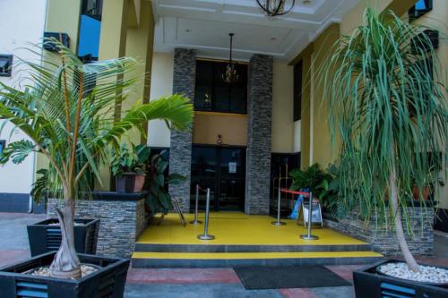 a lobby with potted plants in front of a building at Zoey International Hotels Ltd in Owerri