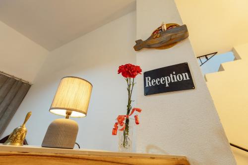 a room with a sign on the wall and a vase with a flower at *NEW IN 2025* - Hotel Subra Atrium in Herceg-Novi