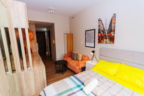 a bedroom with a bed and a couch in it at Modern One BR Makati Condo Swim Gym Parking Netflix Fast 2428 in Manila
