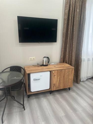 バトゥミにあるSkyHouse Batumiの木製のエンターテイメントセンター(壁掛けテレビ付)