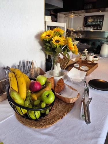 a bowl of fruit on a table with flowers at Omir Bed & Breakfast in Pula