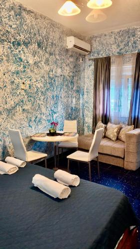 a living room with a couch and a table with chairs at Apartments Ljiljanic in Budva