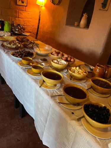 a table with bowls and plates of food on it at Dar Mouna in Aït Ben Haddou
