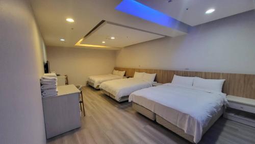 Posteľ alebo postele v izbe v ubytovaní Xingyi Hotel
