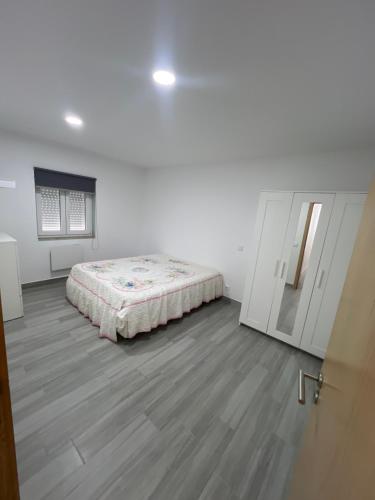 a bedroom with a bed in the middle of a room at Casa bernardino in Esmoriz