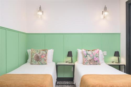 two beds sitting next to each other in a room at FAUNA Montevideo in Montevideo