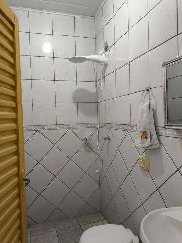 a bathroom with a shower and a toilet at Casa Lilás in Goiás