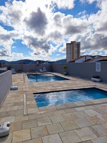 a swimming pool on the roof of a building at Studio 114 Luxury Mogi Das Cruzes in Mogi das Cruzes