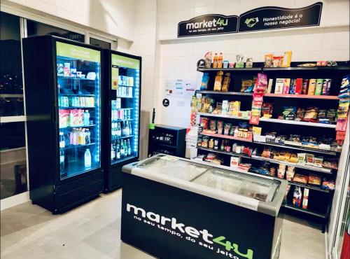 a store aisle with a martini cooler and a pharmacy at Studio 114 Luxury Mogi Das Cruzes in Mogi das Cruzes