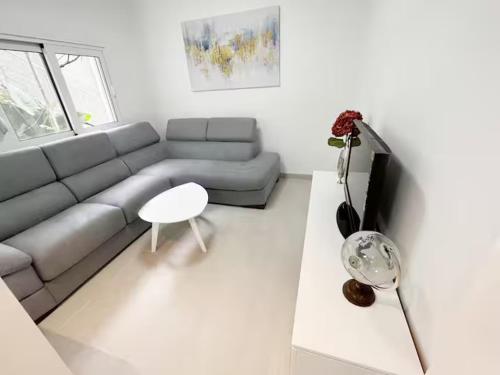 a living room with a couch and a table at Asia Apartments in Škaljari