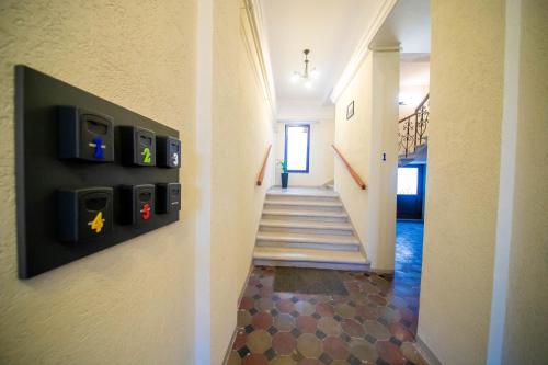 a hallway of a house with a stairwell with two at the end at H&H Luxury Apartments in Arad