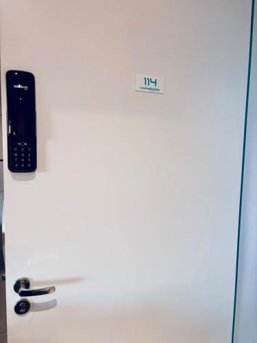 a refrigerator with a cell phone on top of it at Studio 114 Luxury Mogi Das Cruzes in Mogi das Cruzes
