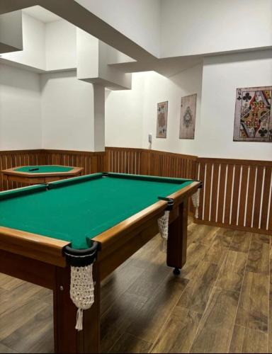 a billiard room with a green pool table at Studio 114 Luxury Mogi Das Cruzes in Mogi das Cruzes