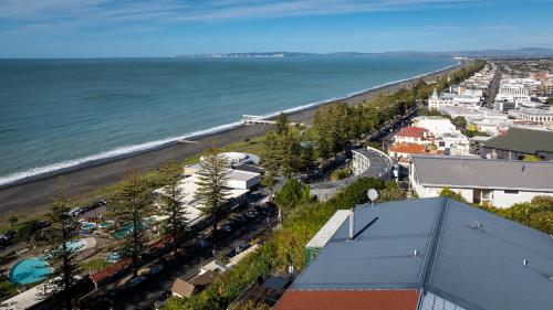 an aerial view of a beach and the ocean at Cape View - Napier Holiday Home in Napier