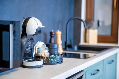 a kitchen counter with a blow dryer on a counter top at H&H Luxury Apartments in Arad