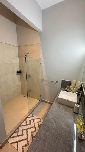 a bathroom with a shower and a sink at La Ramona Charming Hotel in Tamarindo