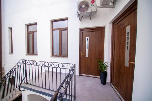 a hallway with a staircase and a door and a plant at H&H Luxury Apartments in Arad