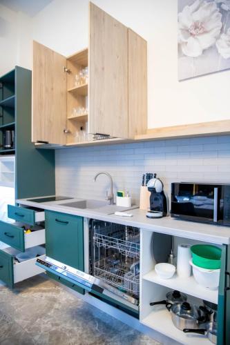 a kitchen with a sink and a dishwasher at H&H Luxury Apartments in Arad