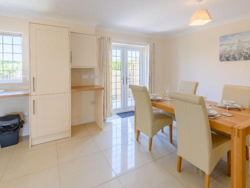a kitchen and dining room with a table and chairs at Dawson Park 1 - Uk12660 in Mablethorpe