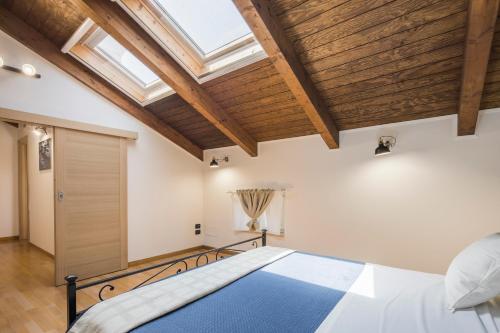 a bedroom with a bed and a skylight at Villa Al Borgo - Villa with Private Garden in Salerno