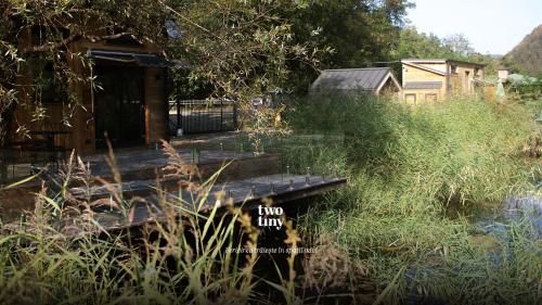 a wooden bridge over a body of water at Two Tiny Houses in Agarcia