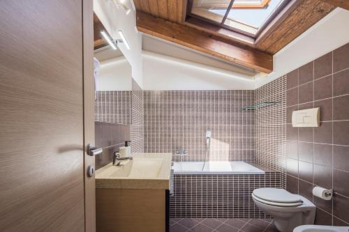a bathroom with a sink toilet and a skylight at Villa Al Borgo - Villa with Private Garden in Salerno