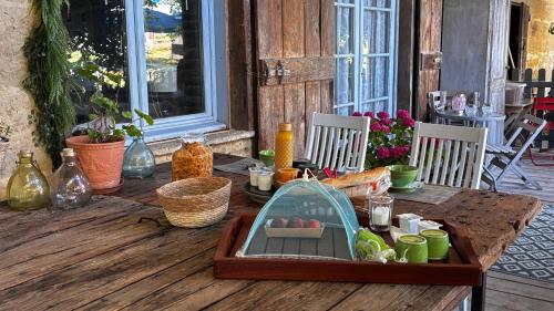 a wooden table with a tray of food on it at Chambre d'hôte SOJANI in Romenay