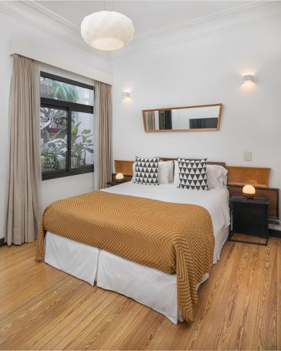 a bedroom with a large bed and a window at FAUNA Montevideo in Montevideo