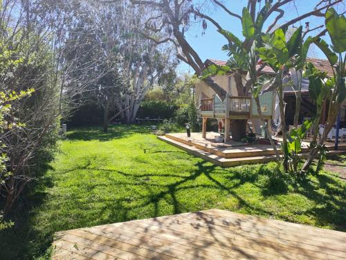 a house with a balcony and a yard at House in the countryside in H̱anniʼel