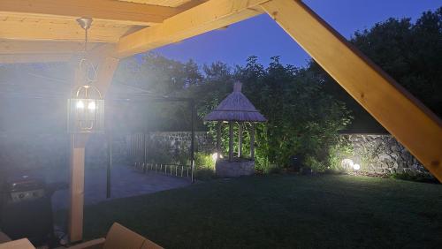 a view of a backyard with a gazebo and a light at Zanzara Guesthouse in Pákozd