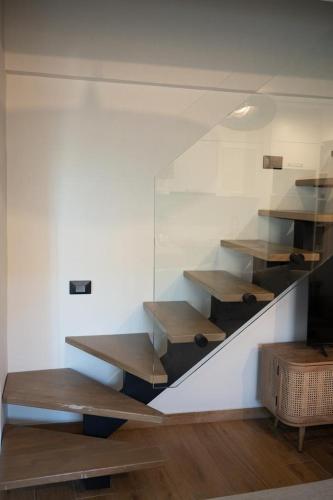 a room with wooden shelves and a stair case at KLA SUITES by PROJECT 86 IKE in Nikiana