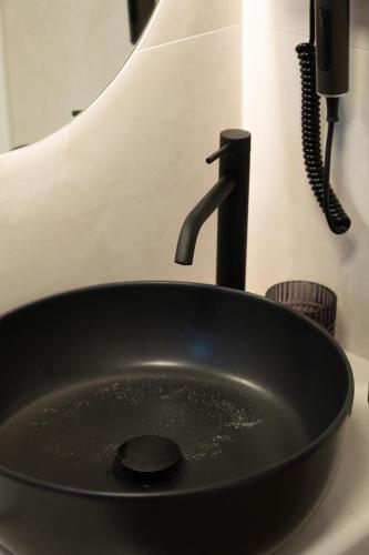 a black sink with a faucet on a counter at KLA SUITES by PROJECT 86 IKE in Nikiana