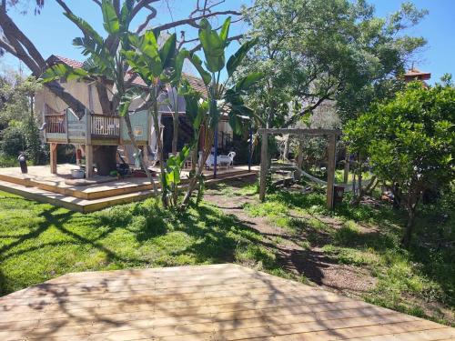 a house with a porch and a tree at House in the countryside in H̱anniʼel