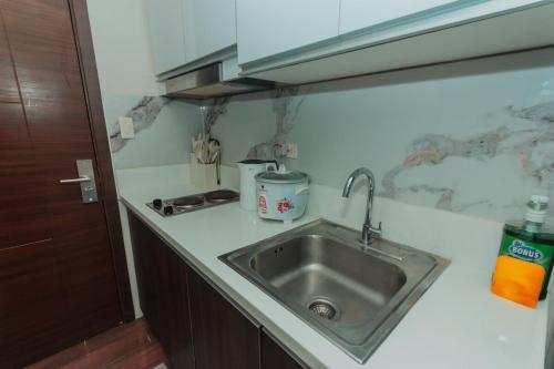 a kitchen counter with a sink and a stove at Urban Luxe 1BR Makati central gym swim Park Fast Internet MB 3301 in Manila
