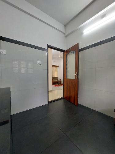 an empty room with a door and a hallway at Achandy Arcade in Kakkadampoyil
