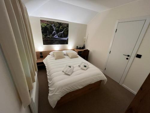 a bedroom with a bed with two towels on it at Motel Lepo Mesto in Strmosten