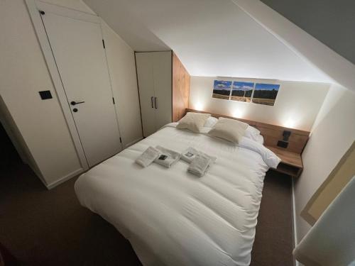 a bedroom with a large white bed with two pillows at Motel Lepo Mesto in Strmosten