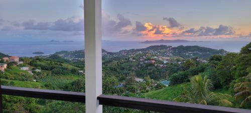 a view of the ocean from a house balcony at WindBlow Villa in Belmont