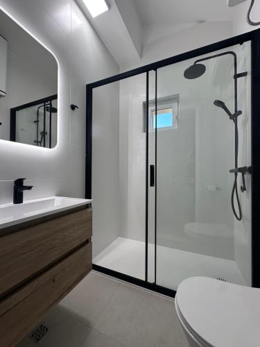 a bathroom with a shower and a toilet and a sink at Apartments Time Off in Zaboric