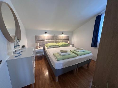 a bedroom with a bed and a desk and a mirror at Apartments Time Off in Zaboric