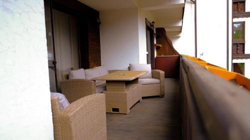 a room with a table and chairs in a building at Apartament Platinvm B&B-Clabucet in Predeal