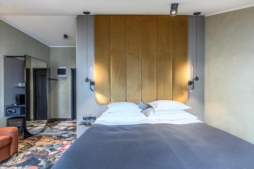 a bedroom with a large bed with a wooden headboard at Hotell Moe 
