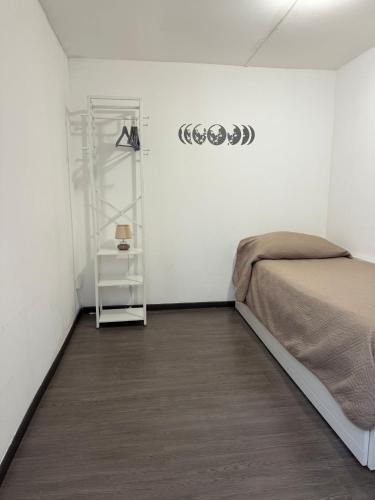 a bedroom with a bed and a shelf on a wall at Marea in Palermo