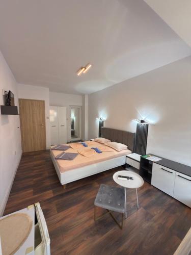 a bedroom with a large bed and a desk at M&D in Nesebar