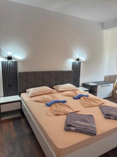 a large bed with two robes on top of it at M&D in Nesebar