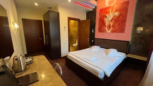 a hotel room with a bed and a bathroom at JEPPESEN RESIDENCE in Almaty
