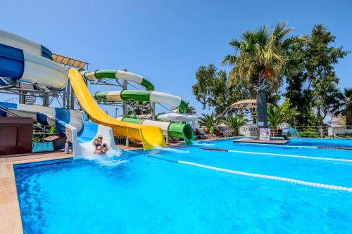 a pool at a resort with a water slide at Flora Garden Ephesus Kusadasi - All Inclusive in Davutlar