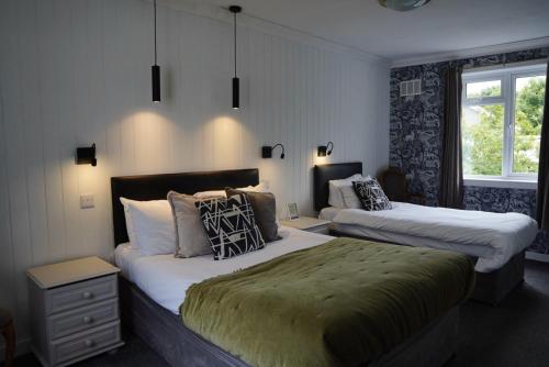 a bedroom with two beds and a window at Lochnell Arms Hotel in Oban