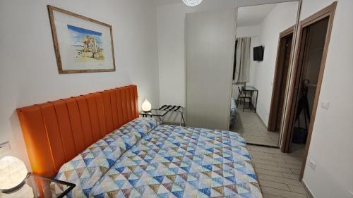a bedroom with a bed with a quilt on it at Almèra Alloggio Turistico - Pescara in Pescara