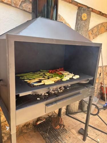a grill with a bunch of food on it at Casa Rural Abuelo Raimundo in Ossa de Montiel